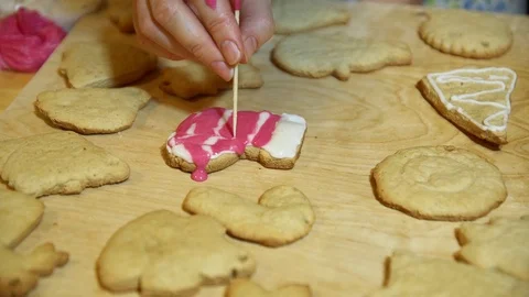Decorating Christmas stocking cakes by hand with icing sugar. Stock Footage 69803811