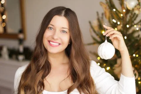 Decorating Christmas tree and winter holidays concept. Happy smiling woman Stock Photos