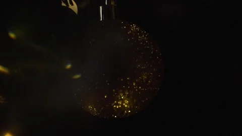 Decorating Christmas tree with balls on the background of bright festive lights Stock Footage 221216371