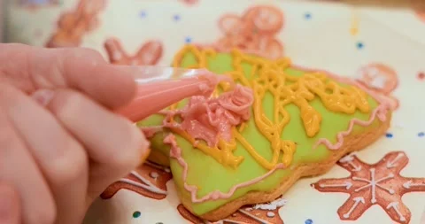 Decorating Christmas Tree Cookie with Icing in Close-Up View Stock Footage 311749630