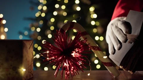 Decorating the Christmas Tree with Festive Candy Cane and Golden Book Stock Footage 331107233