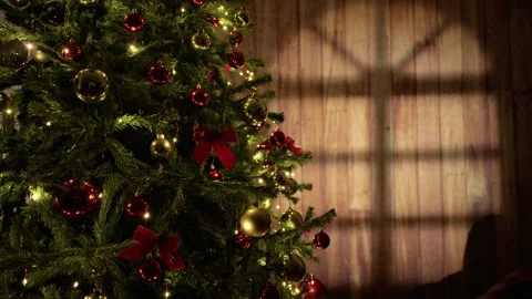 Decorating the Christmas Tree with Glowing Lights and Baubles in Dark Room 库存影片 331106936