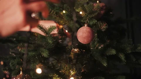Decorating the Christmas tree with lights and toys Stock Footage 167154276