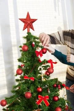 Decorating the christmas tree 写真素材