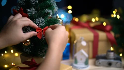 Decorating Christmas Tree. Placing Red Ribbon to The Tree Stock Footage 96343590