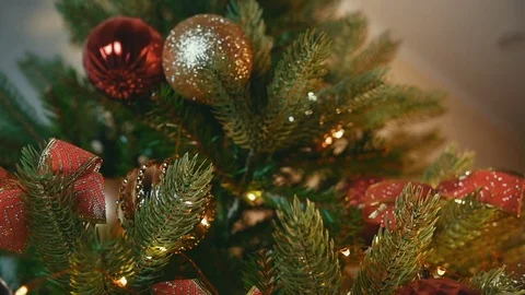 Decorating a Christmas Tree With Red Ball in Slow Motion Stock-Footage 82561893
