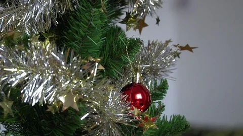 Decorating Christmas tree with a red ball Stock Footage 83583573