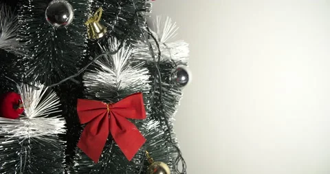 Decorating a Christmas tree with a red loop, creating a beautiful and harmonious Stock Footage 160584903