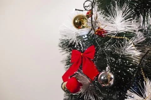 Decorating a Christmas tree with a red loop, creating a beautiful and harmoni Stock Photos
