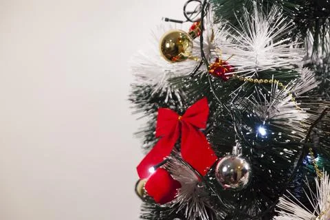 Decorating a Christmas tree with a red loop, creating a beautiful and harmoni Photos