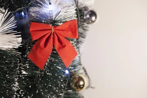Decorating a Christmas tree with a red loop, creating a beautiful and harmoni Photos