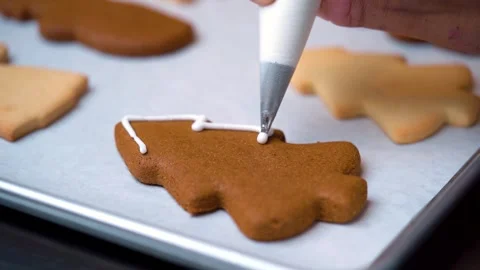 Decorating Christmas Tree Shaped Cookie with White Icing Stock Footage 330517266