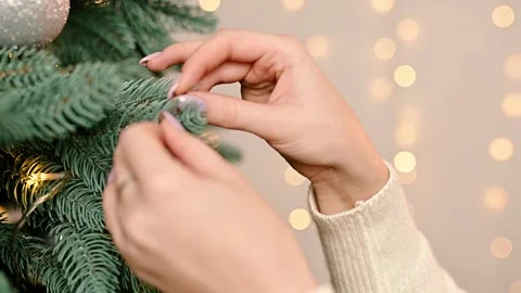 Decorating a Christmas tree slow motion. Female Hands Decorating Christmas Tree Stock Footage 211492387