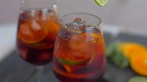 Decorating cocktail sangria with lime Stock Footage 110047084