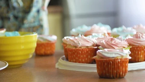 Decorating cup-cake with cream and berry Using cooking bag, confectioner making Stock Footage 77681484