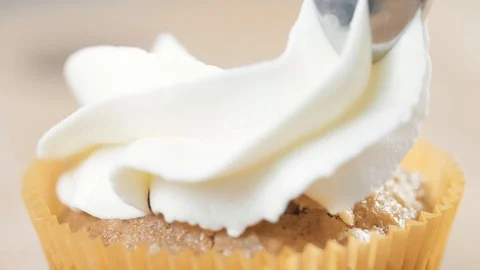 Decorating cup-cake with cream. Using cooking bag, confectioner making cupcakes Stock Footage 88683443