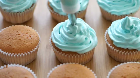 Decorating cupcakes with cream Stock Footage 61875068