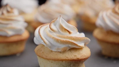 Decorating cupcakes with cream using burner. Roasting meringue. Cooking cakes. Stock Footage 260647812