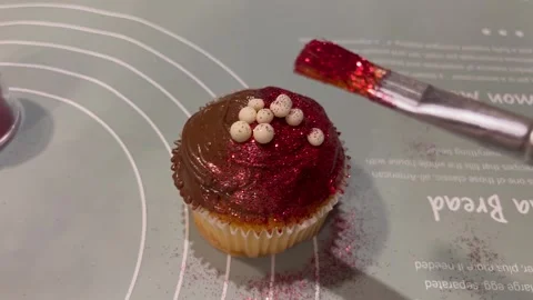Decorating Cupcakes with Edible Glitter and Frosting Stock Footage 345307005