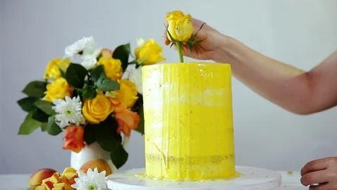 Decorating delicious wedding or party cake with rosebud. Stock Footage 102932071