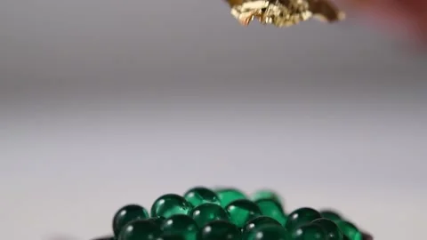 Decorating a dessert of mint capsules with gold leaf. Stock Footage 132043955