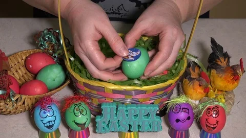 Decorating Easter eggs in a basket Stock Footage 106742652