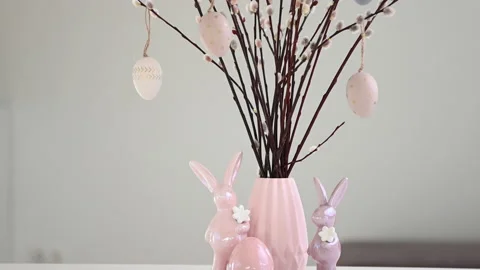 Decorating easter table with vase of eater willow branches with eggs and rabb Stock Footage 170746398