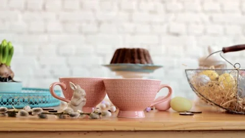 Decorating easter table with vase of eater willow branches with hanging eggs and Stock-Footage 171861939