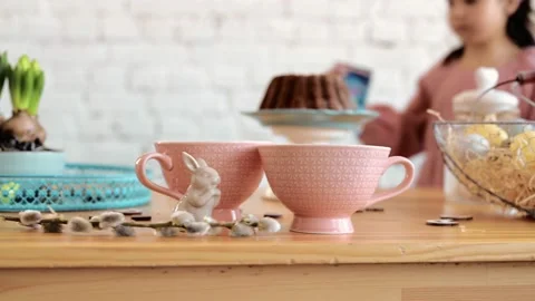Decorating easter table with vase of eater willow branches with hanging eggs and Stock Footage 171973409