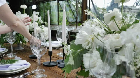 Decorating a Festive table. Wedding Table Decoration with Bouquets of Natural Stock Footage 112601800