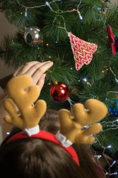 Decorating fur tree with lanterns, garlands and shiny toys Stock Photos