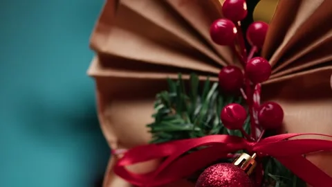 Decorating a Gift Box with Festive Pine Branches and Red Berry Decorations Vídeos de archivo 331107152
