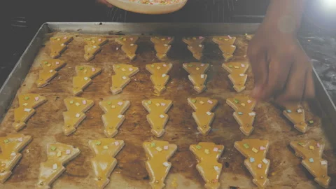 Decorating ginger bread Christmas tree shape cookie Stock Footage 135460589