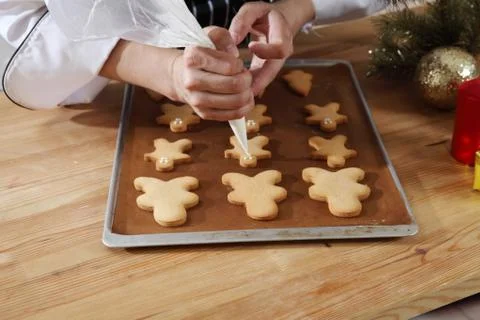 Decorating ginger bread man Stock Photos