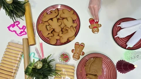Decorating gingerbread boys with love for a magical Christmas touch Video stock 344819662