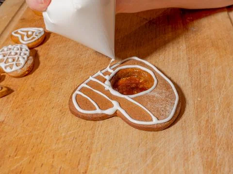 Decorating gingerbread cookie with icing Stock Photos