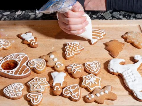 Decorating gingerbread cookies with icing Stock Photos