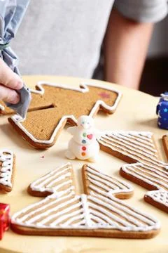 Decorating gingerbread cookies. Stock Photos