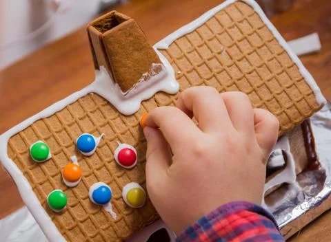 Decorating a gingerbread house Stock Photos