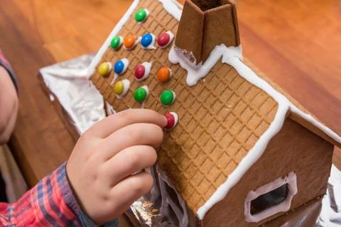 Decorating a gingerbread house Stock Photos