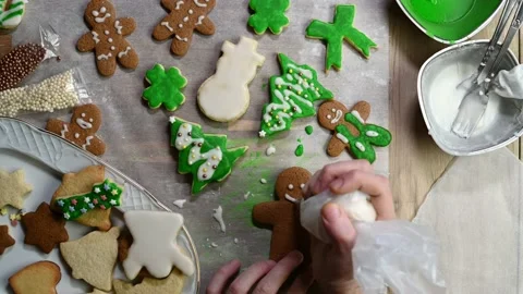 Decorating gingerbread man cookie with royal icing Stock Footage 145229958