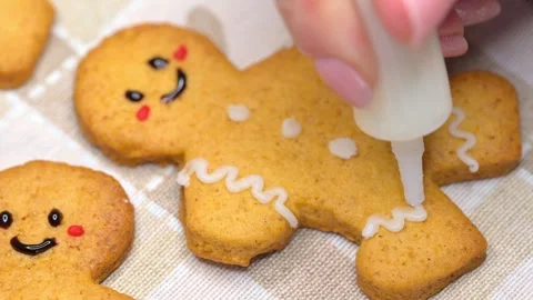 Decorating gingerbread men Stock Footage 294420404