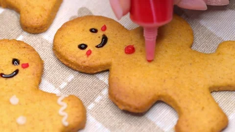 Decorating gingerbread men Stock Footage 294420971