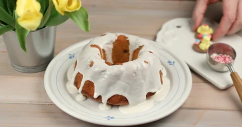 Decorating the glazed Easter cake Stock Footage 104754112