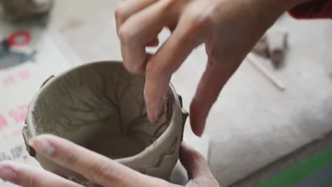 Decorating handmade pottery with clay ornaments and reliefs Stock Footage 342196685