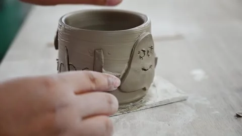 Decorating handmade pottery with clay ornaments and reliefs Stock Footage 342196744