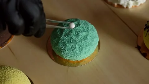 Decorating mini mousse pastry dessert covered with colorful velour. Modern cake. Stock Footage 135084555