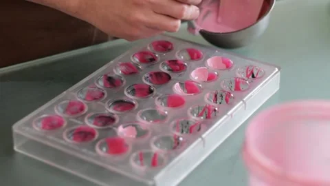 Decorating molds to make chocolates Stock Footage 232522903