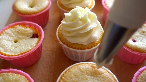 Decorating Muffins with Cream Stock Footage 95864206