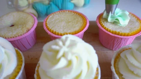Decorating Muffins with Cream Stock Footage 96036814